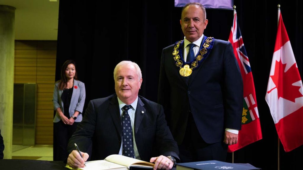 CEO of Sterling Industries, David Van Slingerland’s signing the Order of Vaughan certification